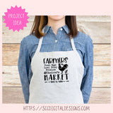 Person wearing a white apron with 'Farmers Market' text and graphics on a wooden background