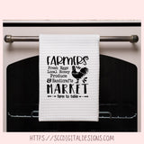 White towel with black text and rooster graphic hanging on a stove handle.
