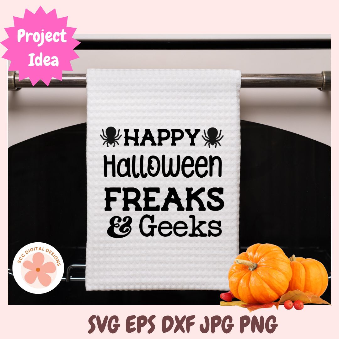 A white waffle-knit kitchen towel hanging on a metal rack, printed with the phrase 'HAPPY Halloween FREAKS & Geeks' in black text with spider graphics. The image includes decorative pink background, a pink 'Project Idea' badge, a circular 'SVG Digital Designs' logo, and orange pumpkins at the bottom right.