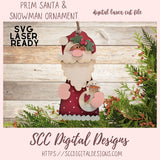 Digital laser cut file of a Santa Claus and snowman ornament with greenery on a wooden background