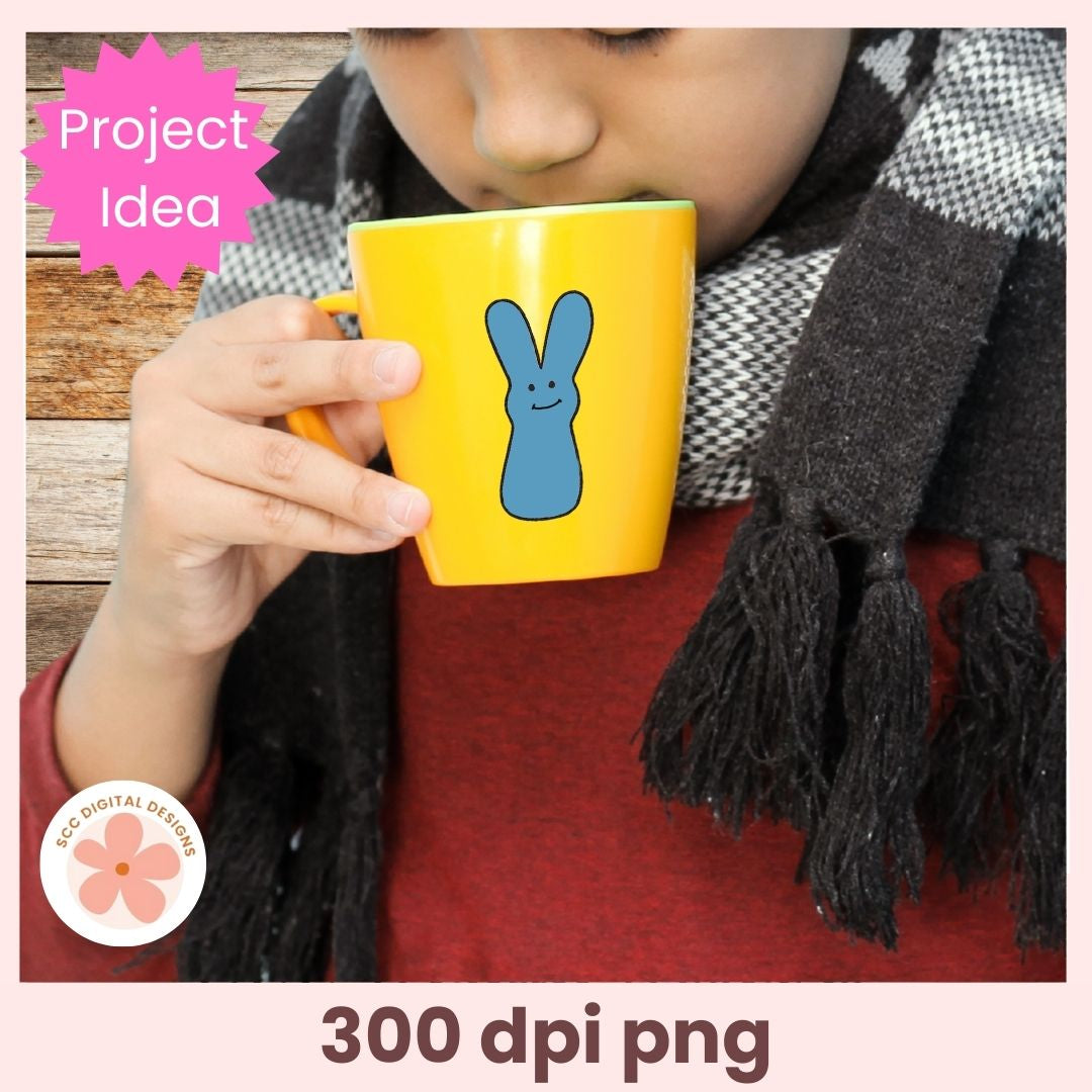 Person holding a yellow mug with a blue rabbit design, wearing a black scarf.