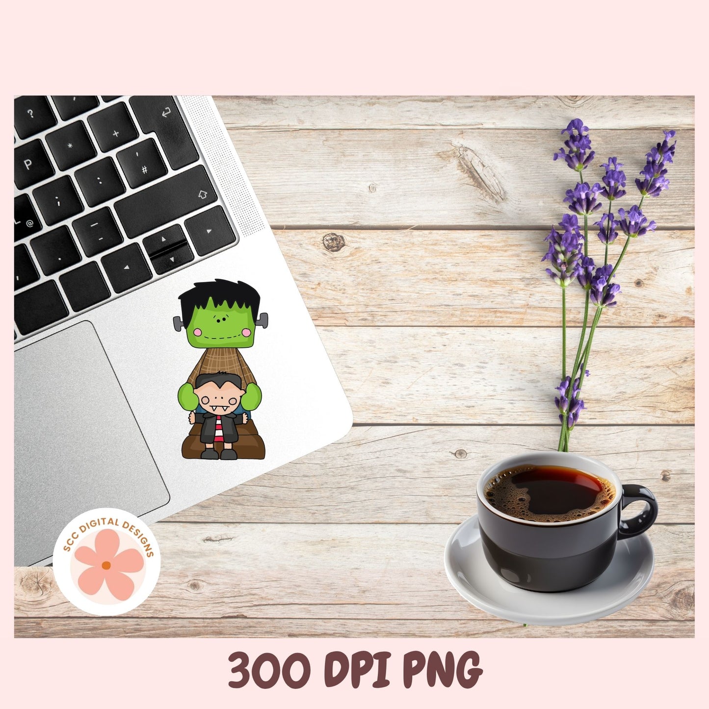 A digital graphic design preview showing a cute cartoon Frankenstein and Boris the Brave sticker applied to a silver laptop trackpad on a rustic wood desk background, alongside a cup of coffee, lavender flowers, and a pink border with text reading '300 DPI PNG' and a circular 'EC Digital Designs' logo.