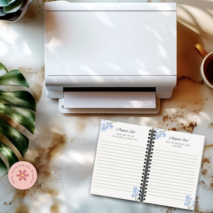 White printer on a marble surface with a planner and coffee cup