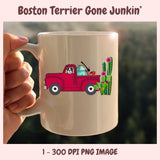 Beige mug with a red truck and Boston Terrier design, held by a hand against a blurred green background.