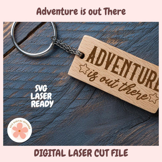 Wooden keychain with 'Adventure is out there' text on a wooden surface, featuring SVG Laser Ready branding.