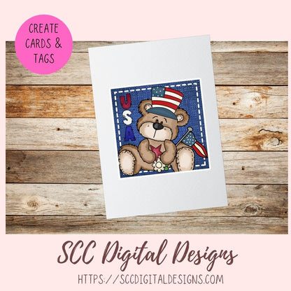 Card with a teddy bear design featuring an American flag on a wooden surface, with SCC Digital Designs branding.