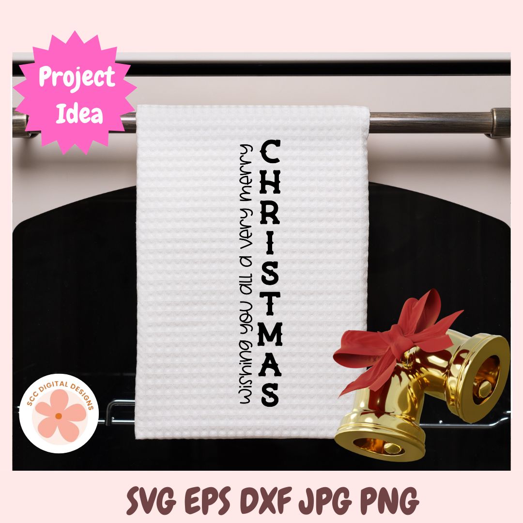 White towel with 'Wishing you a very merry Christmas' text on a rack, with gold bells and red ribbons.