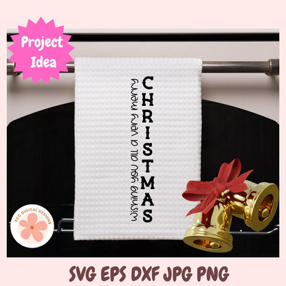 White towel with 'Wishing you a very merry Christmas' text on a rack, with gold bells and red ribbons.