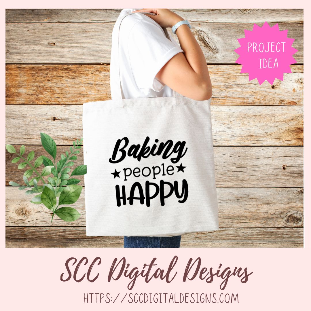 Tote bag with 'Baking people Happy' text on a wooden background, featuring SCC Digital Designs branding.