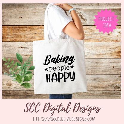 Tote bag with 'Baking people Happy' text on a wooden background, featuring SCC Digital Designs branding.