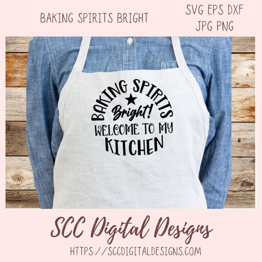 Apron with 'Baking Spirits Bright! Welcome to my Kitchen' text on a wooden background, featuring the brand 'SCC Digital Designs'.