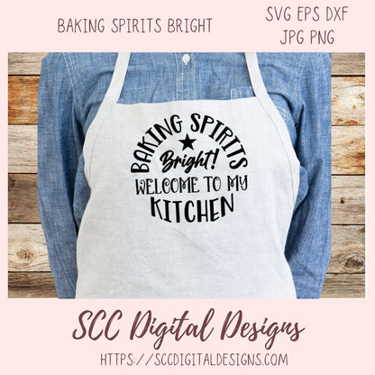 Apron with 'Baking Spirits Bright! Welcome to my Kitchen' text on a wooden background, featuring the brand 'SCC Digital Designs'.