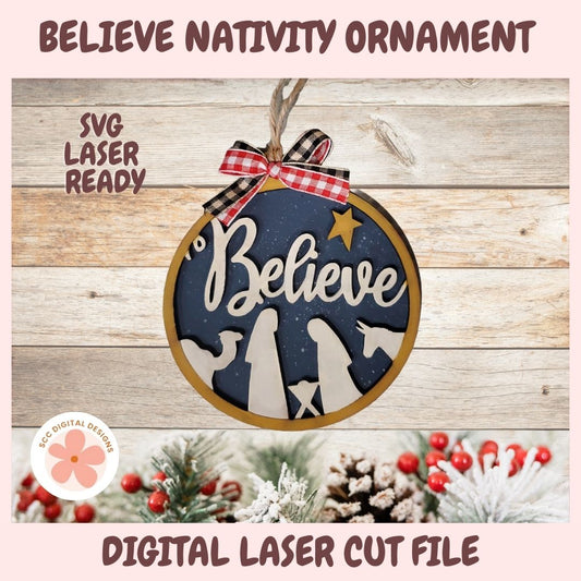 Nativity ornament with 'Believe' text on a wooden background