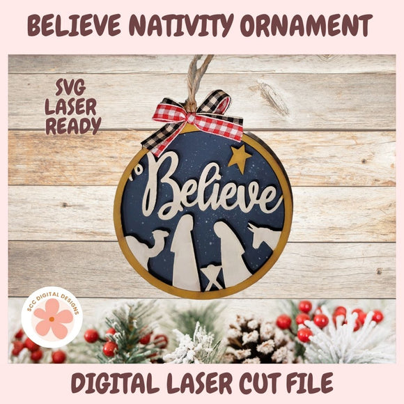 Nativity ornament with 'Believe' text on a wooden background