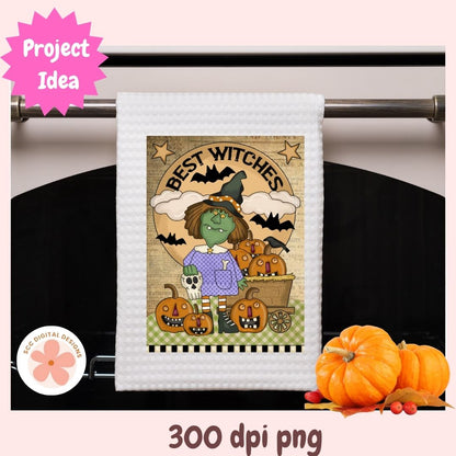 Halloween-themed towel with a witch design on a rack, surrounded by pumpkins.