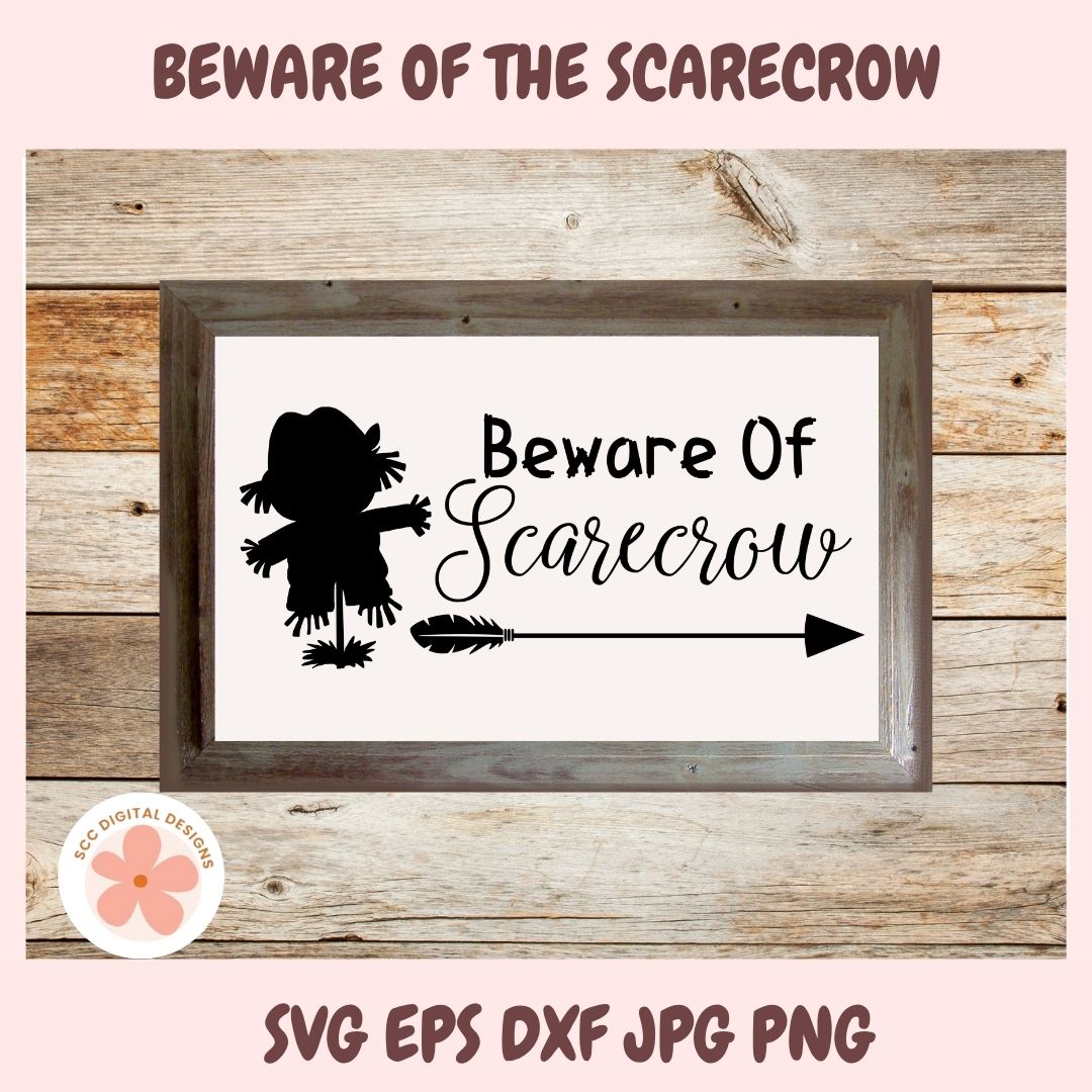 Framed sign with scarecrow silhouette and text 'Beware of Scarecrow' on a wooden background.