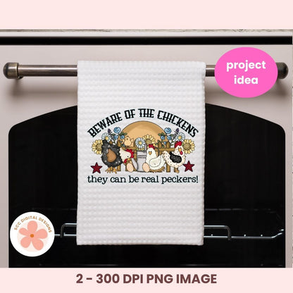 White towel with chicken design and text hanging on a oven rack, with 'project idea' label.