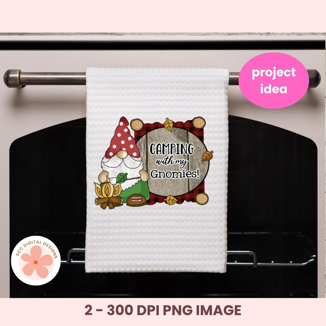 White towel with a gnome design and 'Camping with my Gnomies!' text hanging on an oven handle.