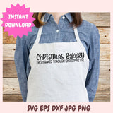 Person wearing a white apron with 'Christmas Bakery' text on a wooden background