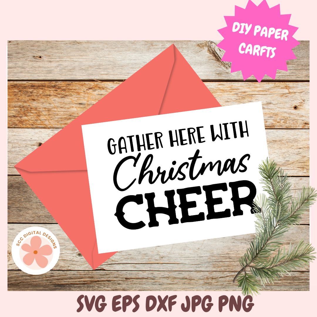 Christmas card with 'Gather here with Christmas cheer' text on a wooden background with an envelope and pine branch.