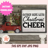 Decorative sign with 'Gather Here with Christmas Cheer' text, red truck, and Christmas tree on a wooden background.