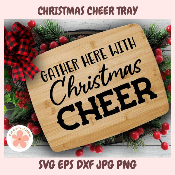 Wooden tray with 'Gather here with Christmas cheer' text, surrounded by Christmas decorations.