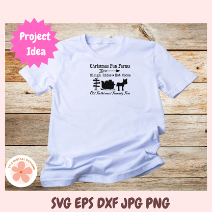 White t-shirt with Christmas-themed design on a wooden surface, featuring text and graphics.