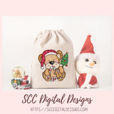 Christmas-themed drawstring bag with teddy bear design, snowman, and snow globe on a light pink background.
