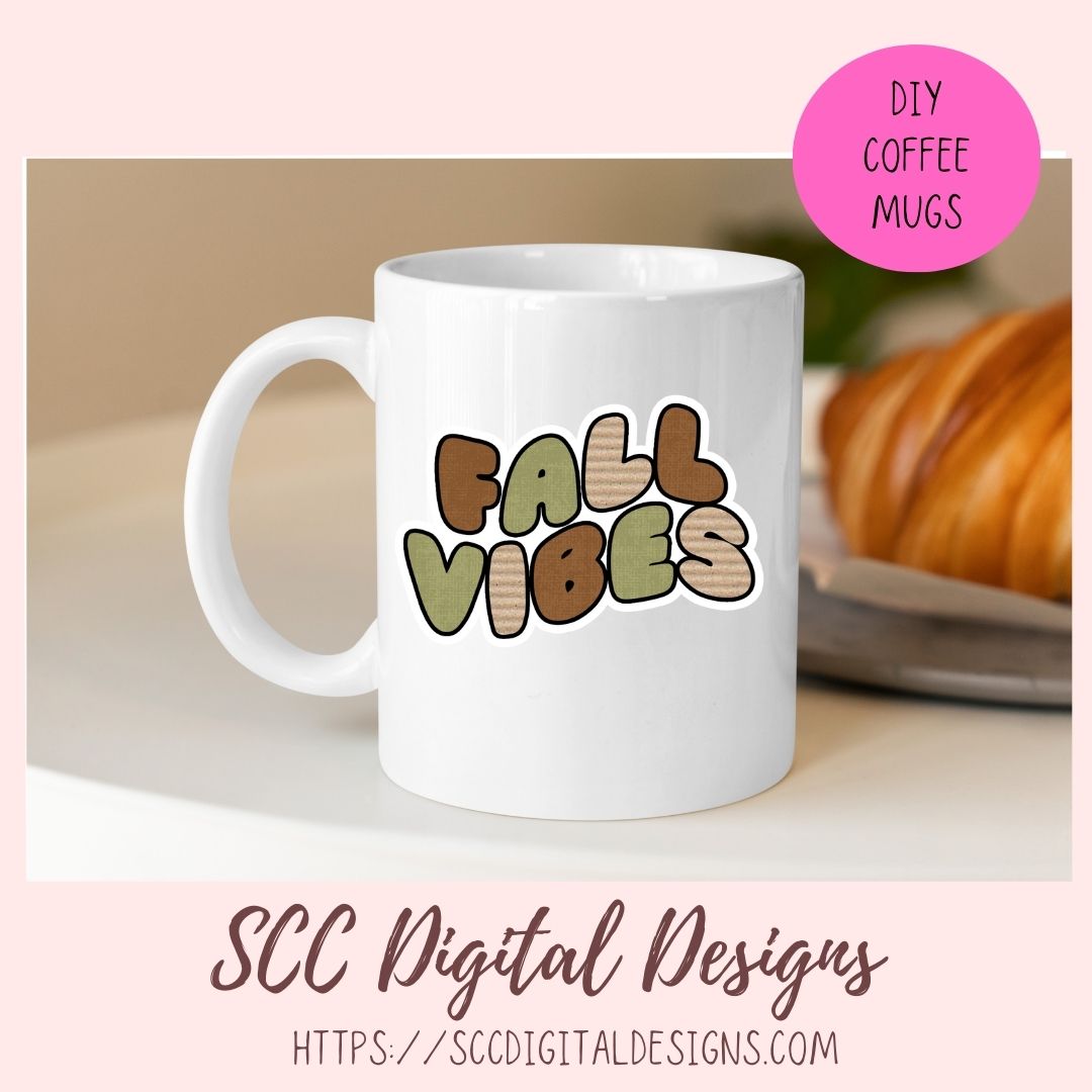 A white ceramic coffee mug with a 'FALL VIBES' graphic in autumn-themed colors, displayed on a light surface with a croissant in the background. A pink circle in the top right says 'DIY COFFEE MUGS' and the bottom has the text 'SCC Digital Designs'.