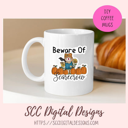 A white ceramic coffee mug with a 'Beware of Scarecrow' autumn graphic, shown in a styled mockup setting with a pink 'DIY COFFEE MUGS' badge and 'SCC Digital Designs' branding.