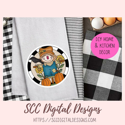A styled product mockup showing a circular autumn scarecrow design printed on a light gray fabric item, alongside black-and-white buffalo plaid and striped fabrics, eggs, and a pink badge reading DIY HOME & KITCHEN DECOR. Text at the bottom says SCC Digital Designs with a website.