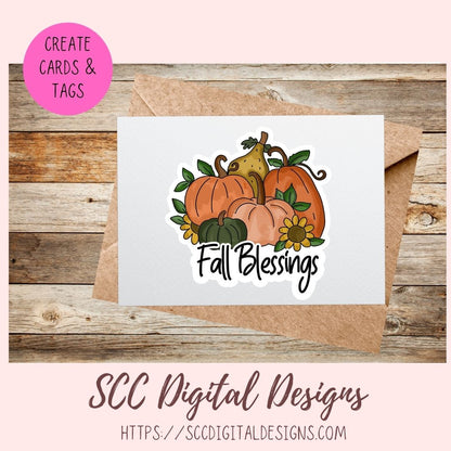 A white greeting card with an autumn illustration of pumpkins, a pear, sunflowers, and the words 'Fall Blessings,' shown with a kraft envelope on a rustic wood background. A pink circle says 'Create Cards & Tags,' and 'SCC Digital Designs' appears at the bottom.
