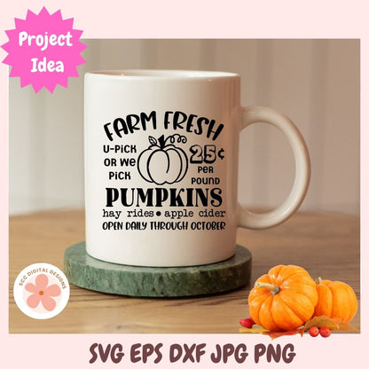 White mug with pumpkin-themed text on a wooden surface, surrounded by pumpkins.