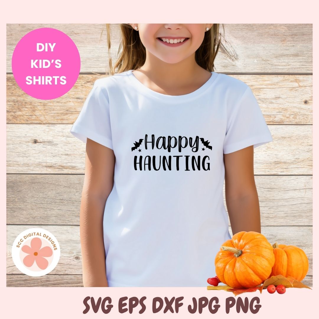 Child wearing a white t-shirt with '#Happy Haunting' text, surrounded by pumpkins on a wooden background.