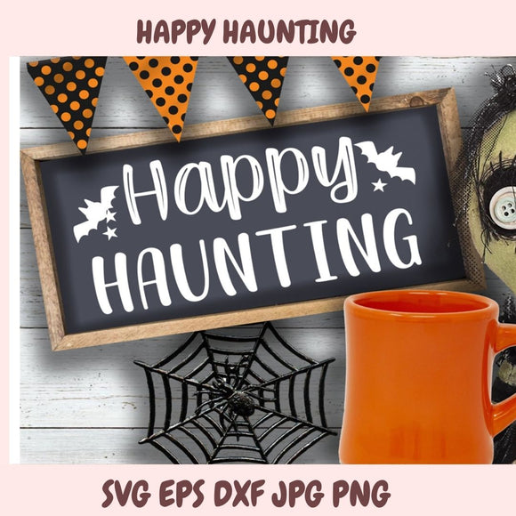 Halloween-themed sign with 'Happy Haunting' text, orange mug, and decorative elements on a wooden surface.