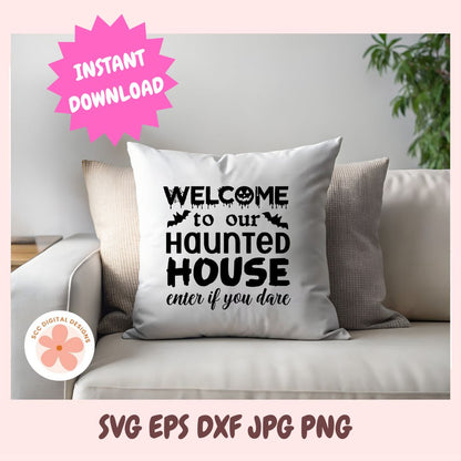 A square white throw pillow with black text reading 'WELCOME to our HAUNTED HOUSE enter if you dare' is styled on a light beige sofa. The scene includes a pink burst that says 'INSTANT DOWNLOAD' and text at the bottom reading 'SVG EPS DXF JPG PNG'.