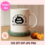 White mug with Halloween-themed design on a wooden table with pumpkins.