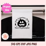 White towel with Halloween design hanging on a rack, featuring 'Jack-O-Lantern Farms' text and pumpkin graphic.
