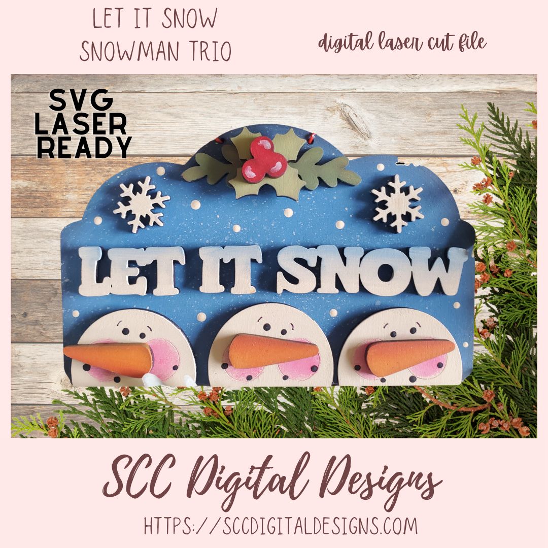 Digital laser cut file design with 'Let It Snow' text and snowmen faces on a wooden background.