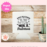 Can Cooler with 'Life is good in the trailerhood' design on a wooden surface with a cactus plant.