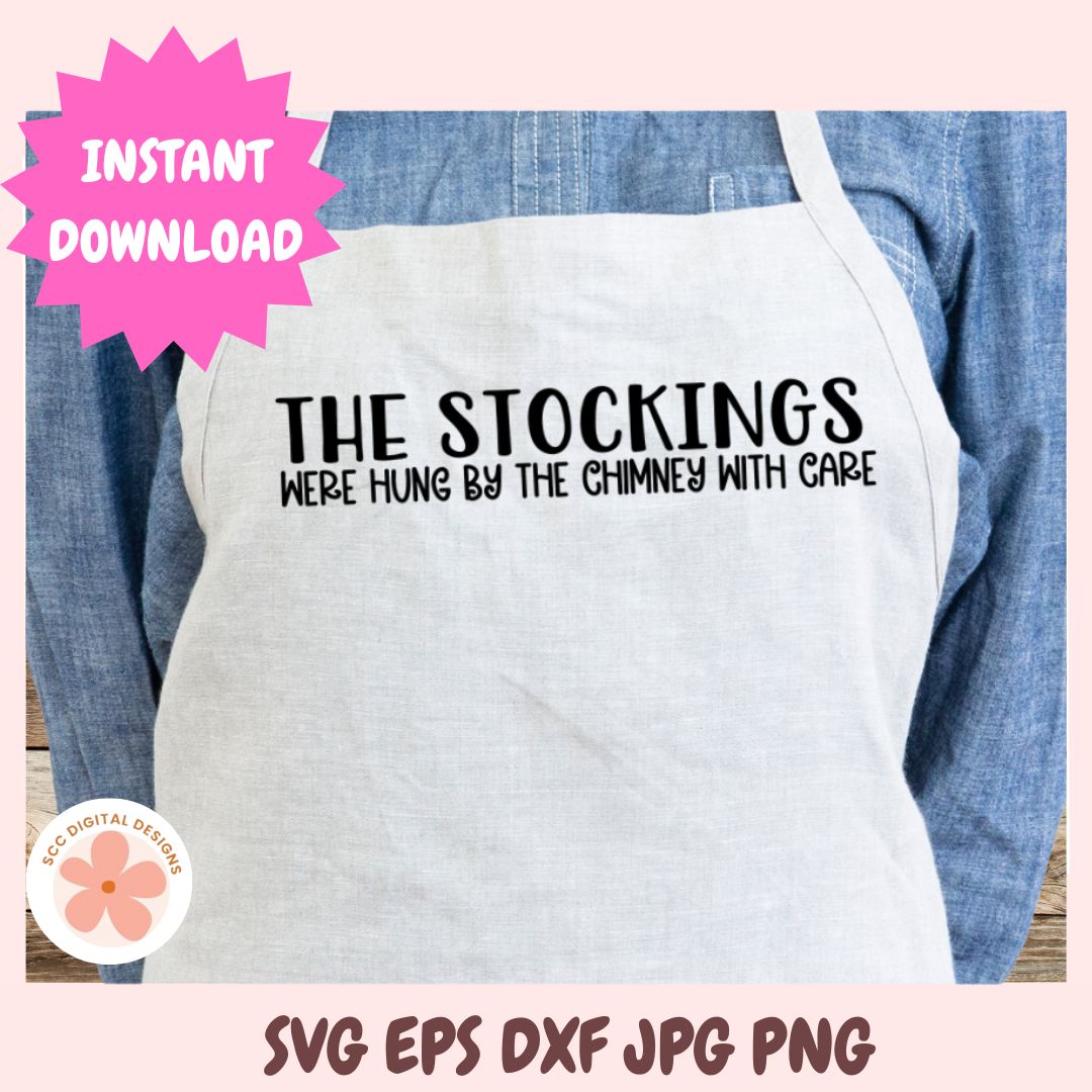 White apron with text 'THE STOCKINGS WERE HUNG BY THE CHIMNEY WITH CARE' on a pink background