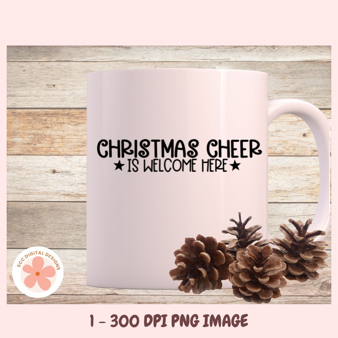 Mug with 'Christmas Cheer is Welcome Here' text and pinecones on a wooden background