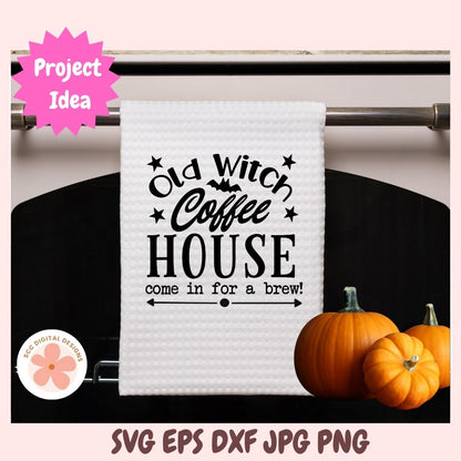 White towel with 'Old Witch Coffee House' text on a rack with pumpkins.