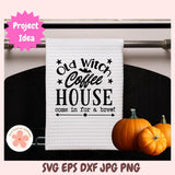 White towel with 'Old Witch Coffee House' text on a rack with pumpkins.