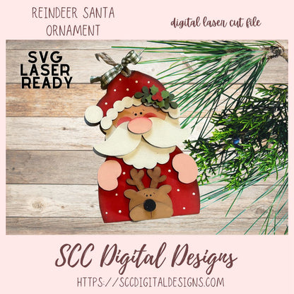Digital laser cut file of a reindeer Santa ornament with greenery on a wooden surface, featuring 'SVG Laser Ready' text.