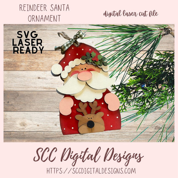 Digital laser cut file of a reindeer Santa ornament with greenery on a wooden surface, featuring 'SVG Laser Ready' text.