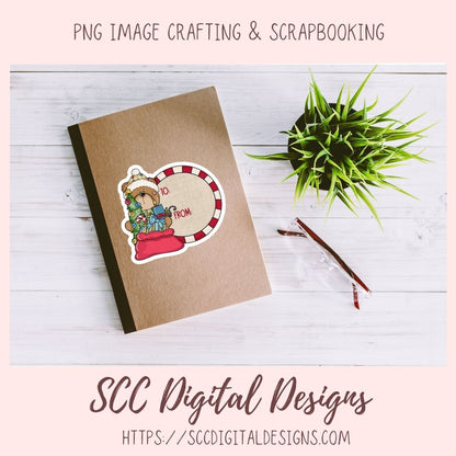 A kraft paper notebook or cardstock sheet with a die-cut sticker showing a teddy bear in a Santa hat and the words 'MERRY FROM SC', styled on a white wood background with a small green plant and a pencil. Text at the top reads 'PNG IMAGE CRAFTING & SCRAPBOOKING' and text at the bottom reads 'SCC Digital Designs' with a website URL.