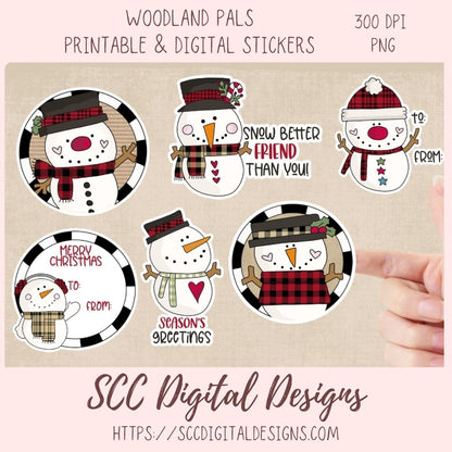A set of six circular digital Christmas snowman stickers shown on a beige background with a hand pointing to one sticker. The top text reads 'WOODLAND PALS PRINTABLE & DIGITAL STICKERS' and '300 DPI PNG'.