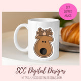 White mug with a reindeer design on a table with a pink circle and text overlay.