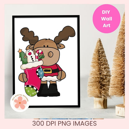 A framed cartoon Christmas moose wall art print shown on a light gray surface with decorative bottle trees. The print features a brown moose wearing a red Santa-style coat and black boots, holding a pink stocking with green and white polka dots.